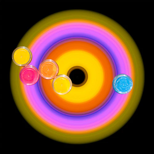Five containers placed over a yellow, orange, pink, and green Circular Light exposure